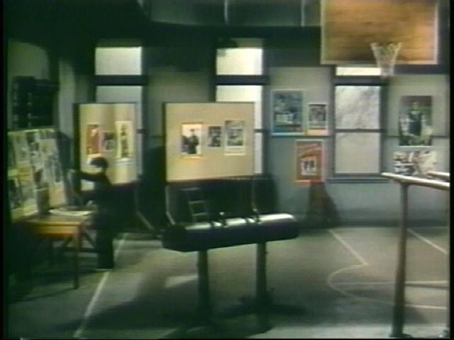 Figure 7: Peter (Dean Stockwell) displays his poster in the gym, The Boy with the Green Hair.